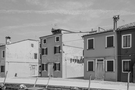 a black and white photo of a row of houses
