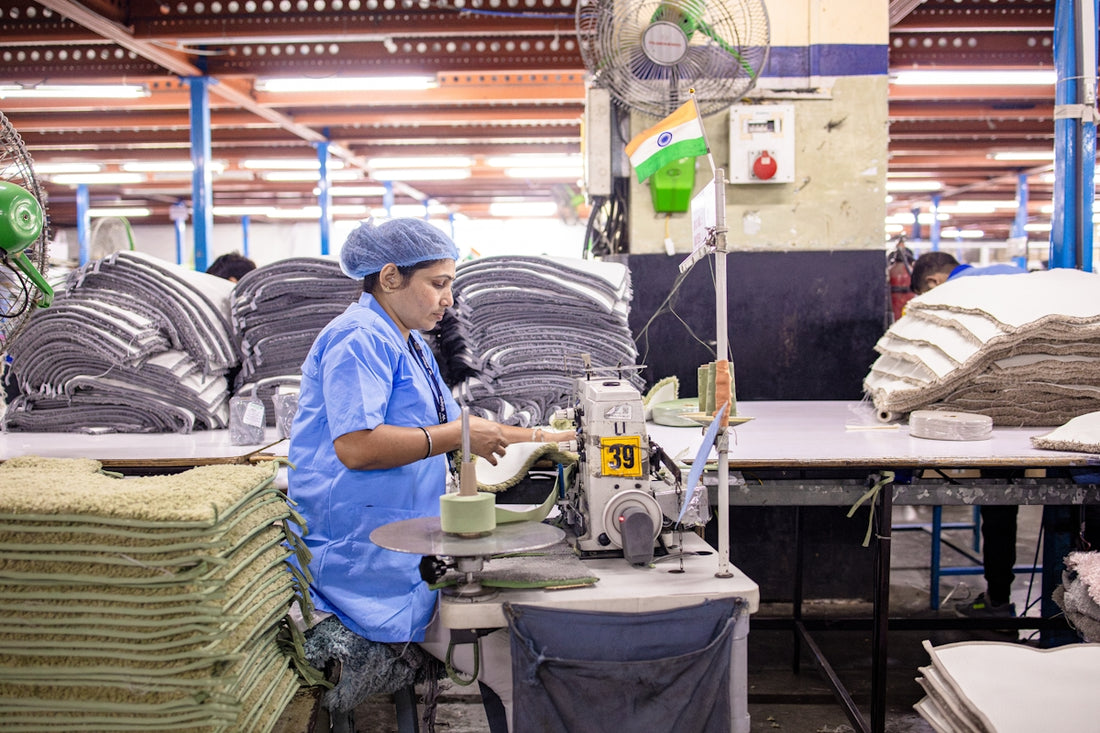 A factory worker operates a machine.
